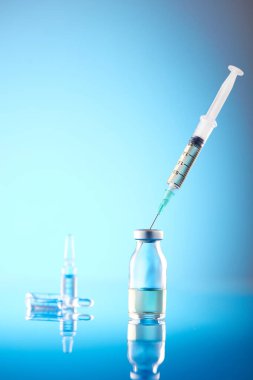 Vaccine vial dose flu shot drug needle syringe.