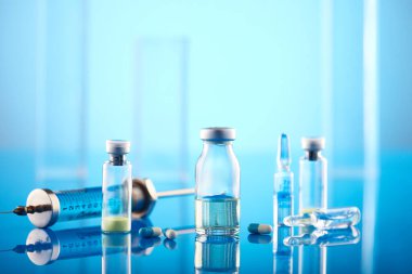Vaccine vial dose flu shot drug needle syringe.