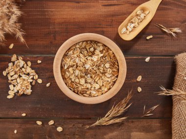 Oat flakes, rolled oats in wooden bowl 