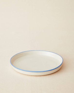 Handmade ceramic plate on beige background.