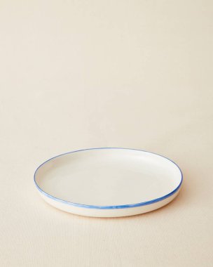 Handmade ceramic plate on beige background.
