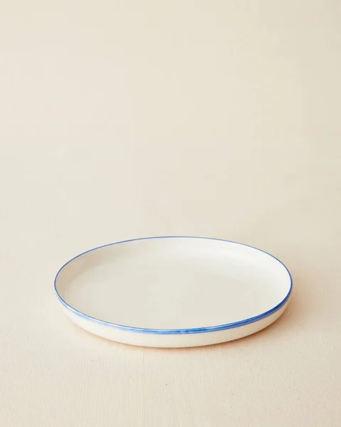 Handmade ceramic plate on beige background.
