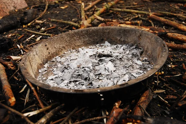 The white and gray wood ash is from the campfire at the campsite