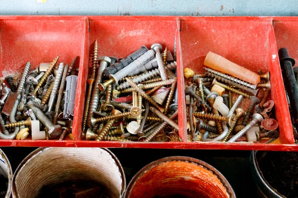 metal bolts, screws and nuts on wooden background, close-up