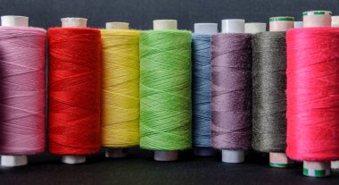 colorful threads for sewing on white background