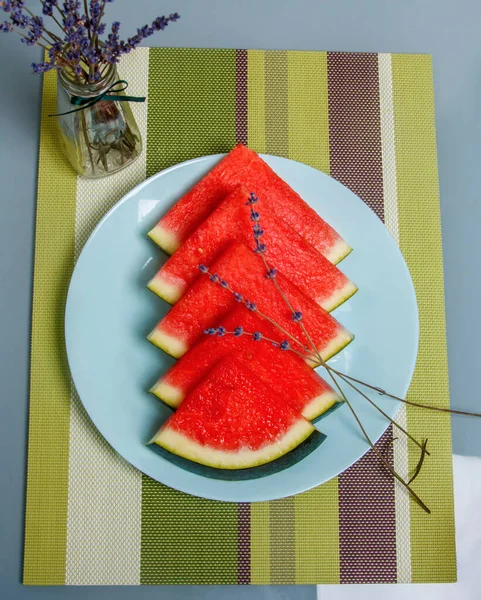 sliced watermelon on plate on a white background
