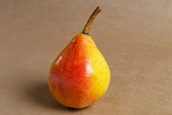 yellow pear close up on craft paper