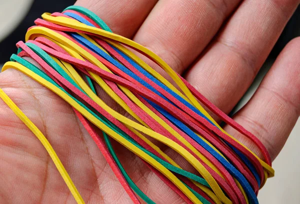 close-up of a person's hand holding a cable