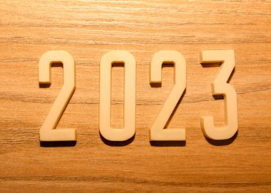 2023 numbers on a wooden background. New Year.