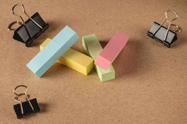 School office stationery on a brown paper background with space for text, top view. Concept of back to school, education and school stationery