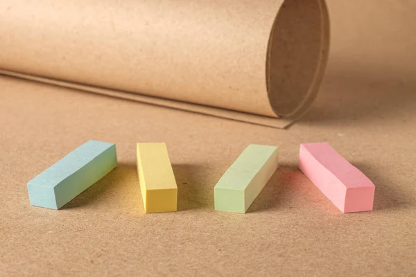 Pile colored block of post notes  on brown craft paper background , closeup