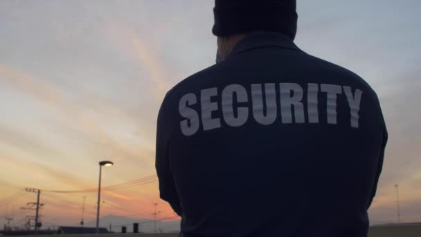 Security Guard Looking Street Sunset — Stockvideo