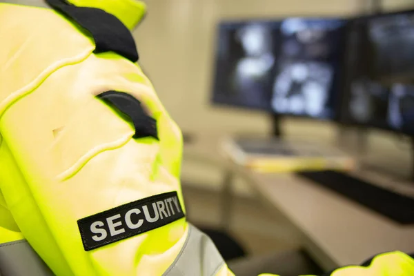 Security team watching over CCTV surveillance monitors.