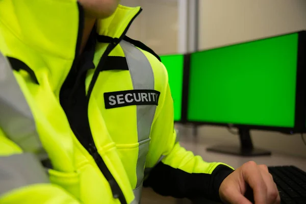 Security team watching over CCTV surveillance monitors.