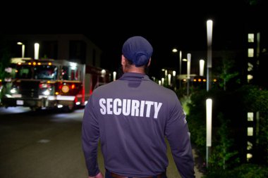 Geceleri ticari alanda güvenlik görevlisi ve ambulans.