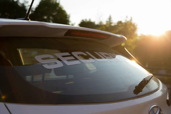 Security car patrolling streets before sunset