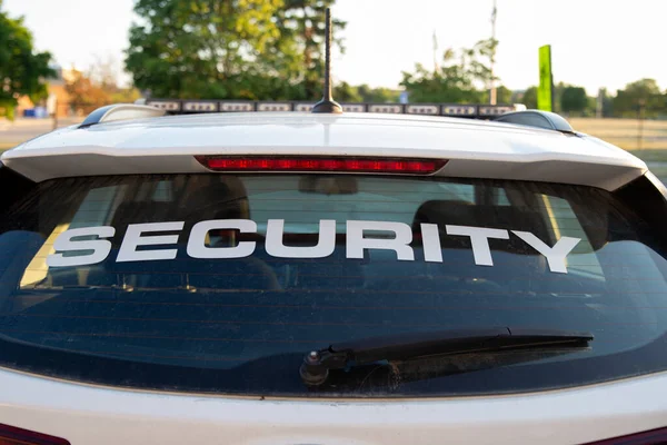 Security car patrolling streets before sunset