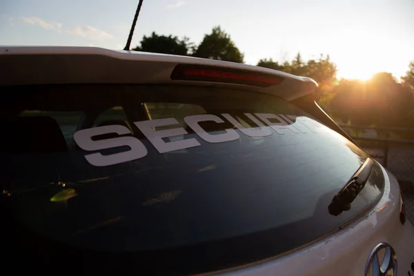 Security car patrolling streets before sunset