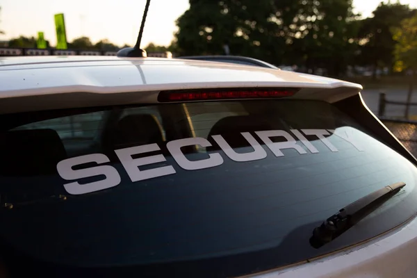 Security car patrolling streets before sunset