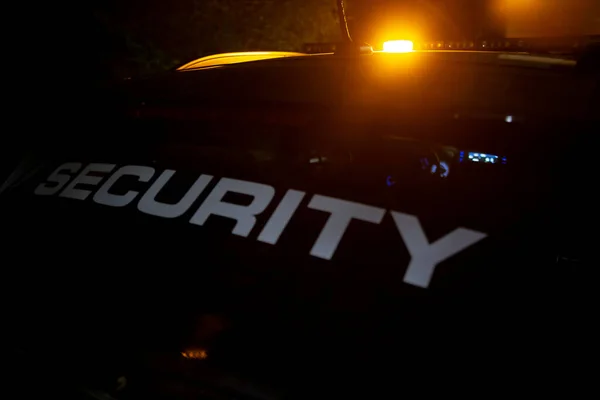 Security car patroling at construction site at night city