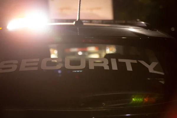 Security car patroling at construction site at night  city