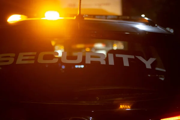 Security car patroling at construction site at night  city