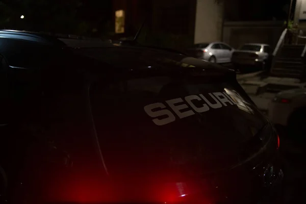 Security car patroling at construction site at night  city