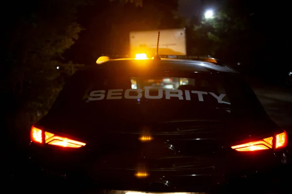 Security car patroling at construction site at night  city