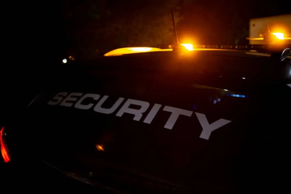 Security car patroling at construction site at night  city