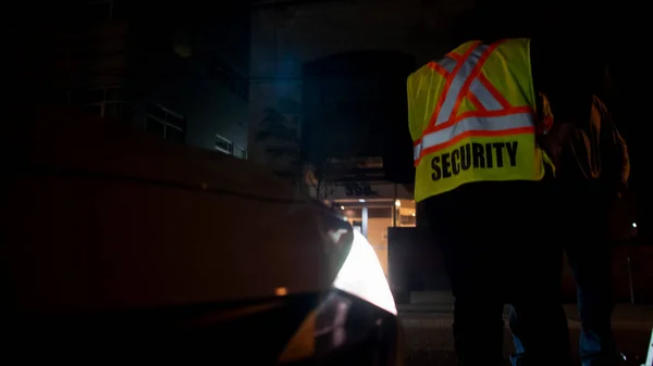 Security car patroling at construction site at night  city