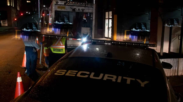 Security car patroling at construction site at night  city