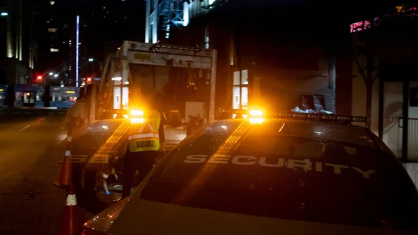 Security car patroling at construction site at night  city