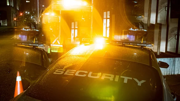 Security car patroling at construction site at night  city