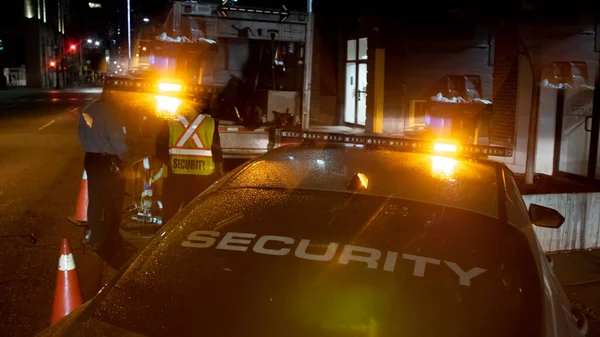 Security car patroling at construction site at night  city