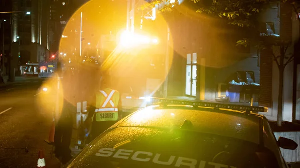 Security car patroling at construction site at night  city