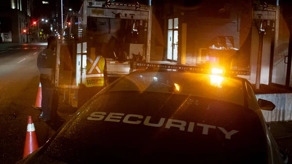 Security car patroling at construction site at night  city