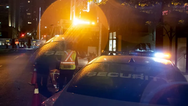 Security car patroling at construction site at night  city