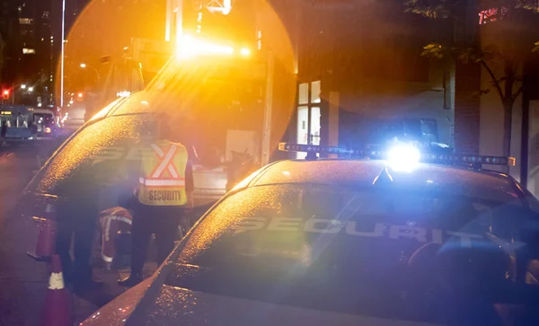 Security car patroling at construction site at night  city