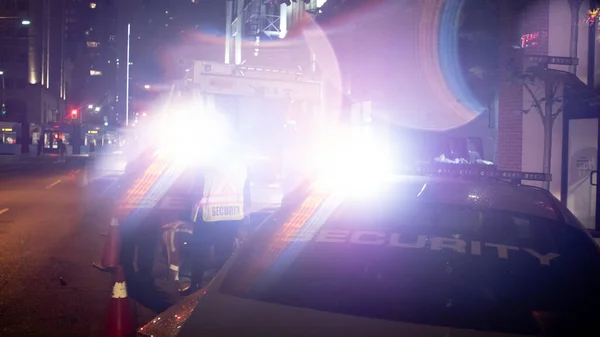 Security car patroling at construction site at night  city