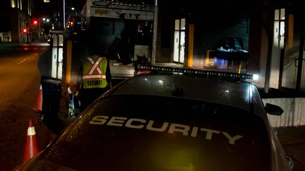 Security car patroling at construction site at night  city