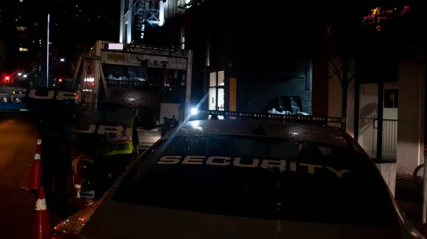 Security car patroling at construction site at night  city