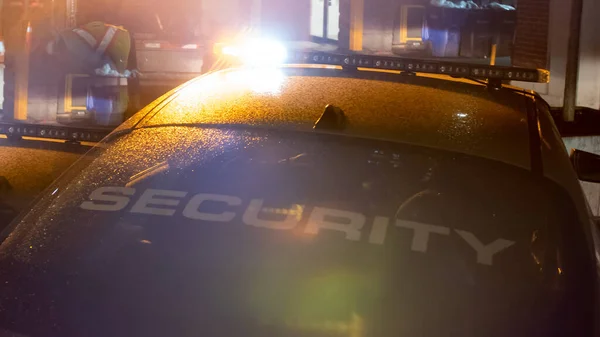 Security car patroling at construction site at night  city