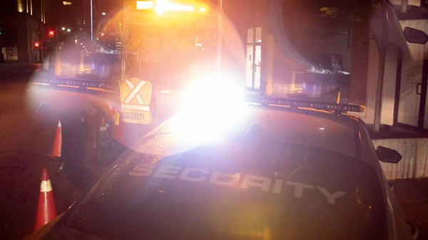 Security car patroling at construction site at night  city