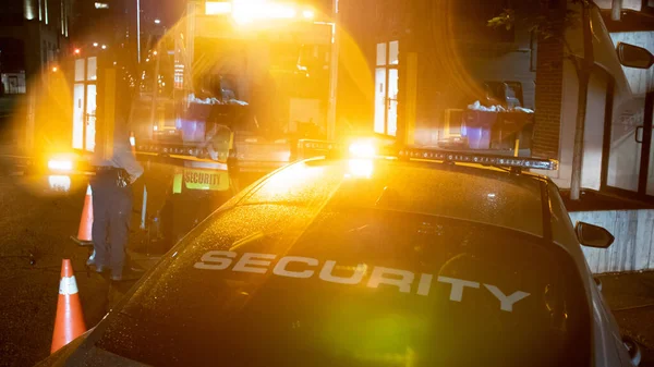 Security car patroling at construction site at night  city