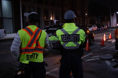 Security guard patroling at construction site at night  city