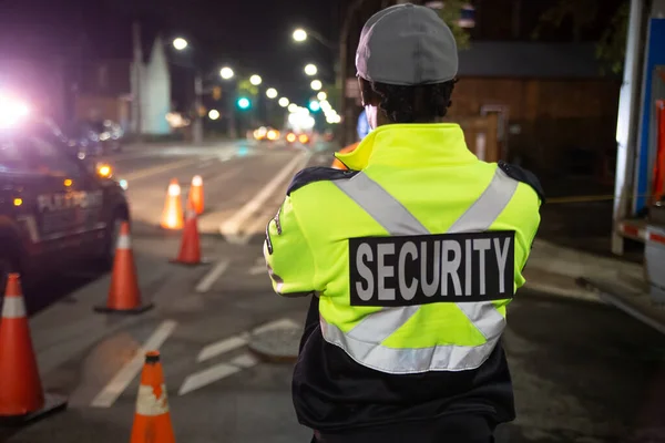 Security guard patroling at construction site at night  city