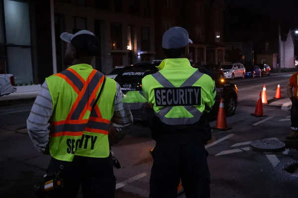 Security guard patroling at construction site at night  city