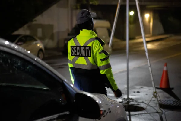 Security guard patroling at construction site at night  city