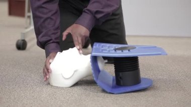 Staff is practicing CPR first aid with the AED with adult and infant dummy dolls.