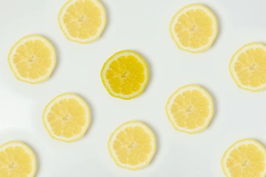 Refresh round lemon slices on white background. Bright yellow lemon slices. Organic citrus. High quality photo.